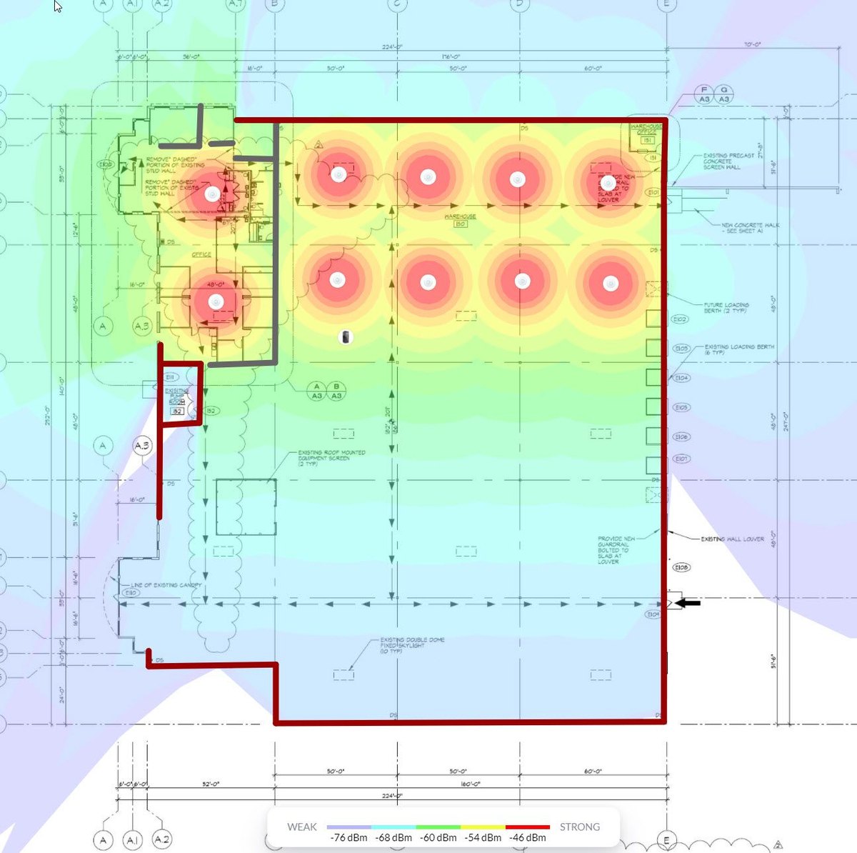 Wireless coverage plot over a building drawing; the coloured signal fields extend beyond the building outline marked in red